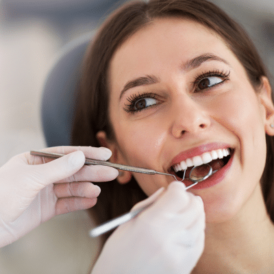 Woman smiling while getting her teeth worked on, representing dentists in lansdowne