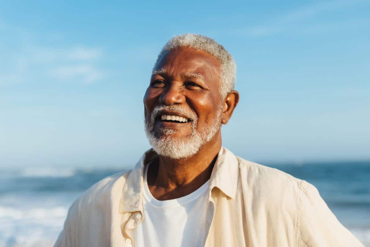 man with beautiful teeth smiling blue sky
