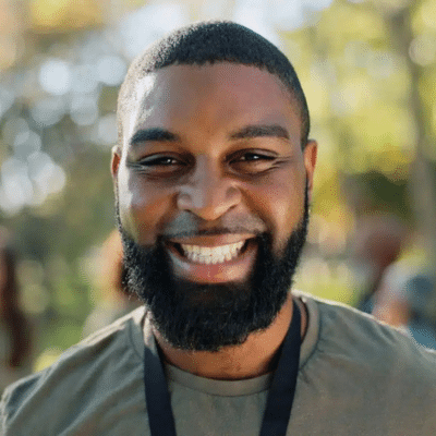 A man with a beard smiling, representing dental implants in lansdowne va