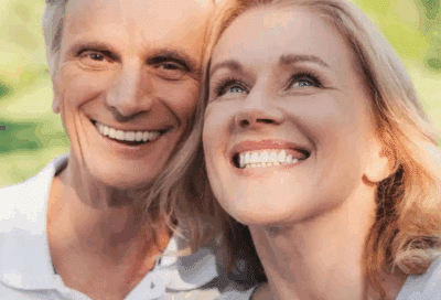 a man and woman smiling, representing dental cleanings in Lansdowne VA