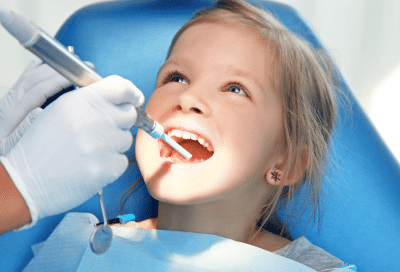 Child receiving dental care at the dentist, representing benefits of early dental care for children