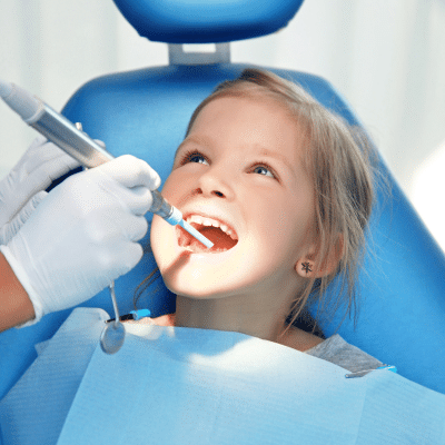Child receiving dental care at the dentist, representing benefits of early dental care for children