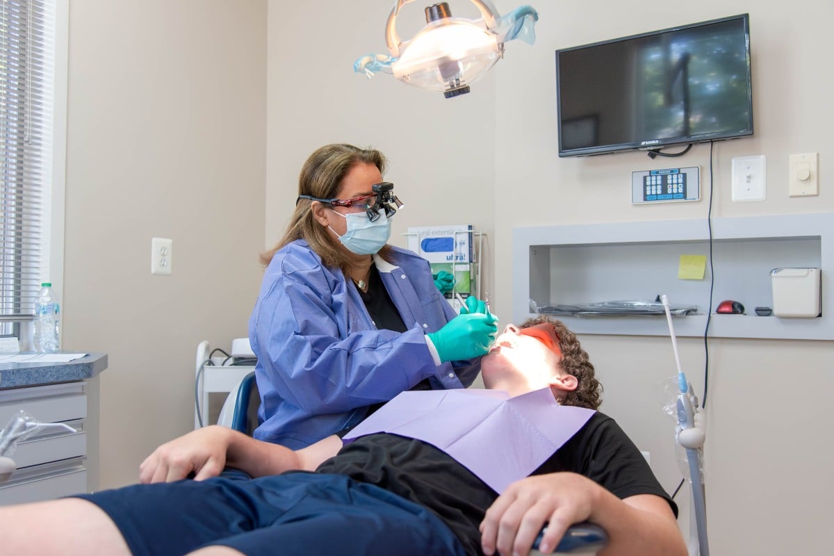 General dentist performing comprehensive dental exam in lansdowne, va at lansdowne dentistry by design