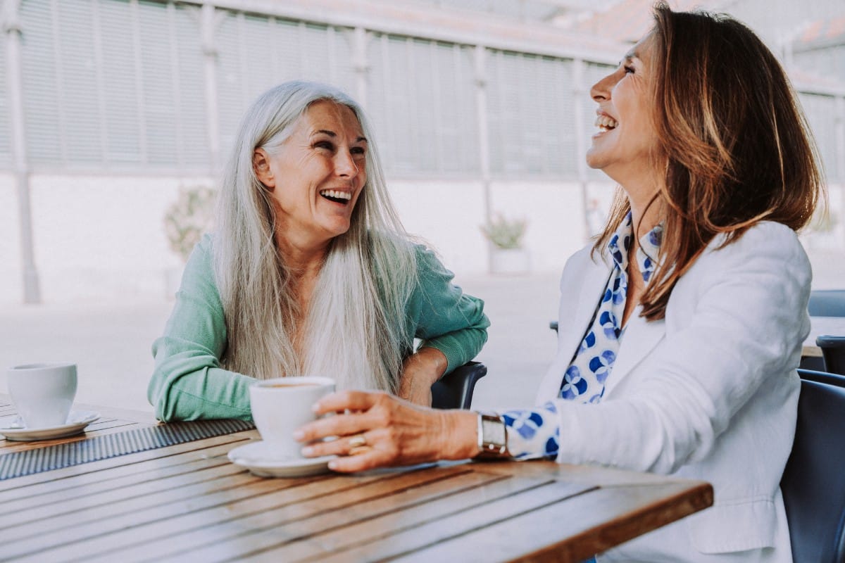 Two women laughing together in Leesburg, Virginia, reflecting confidence and healthy smiles after dental care