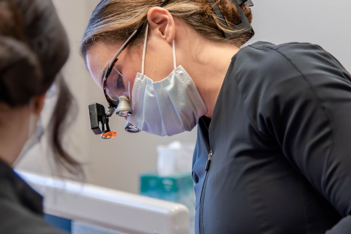 Dentist using magnification loupes for precise dental care in Lansdowne, VA