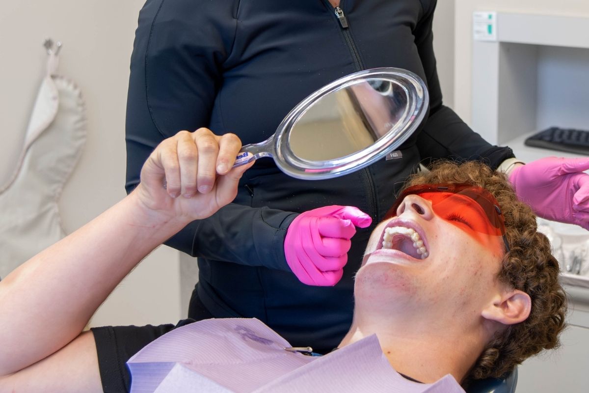 Patient reviewing smile during dental exam at Lansdowne Dentistry by Design in Lansdowne, VA